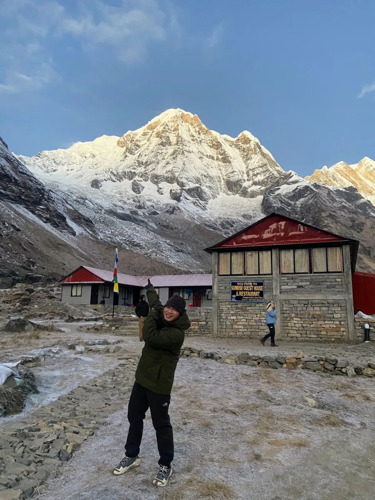 Vu Nguyen standing in front of a snow-capped mountain at sunrise